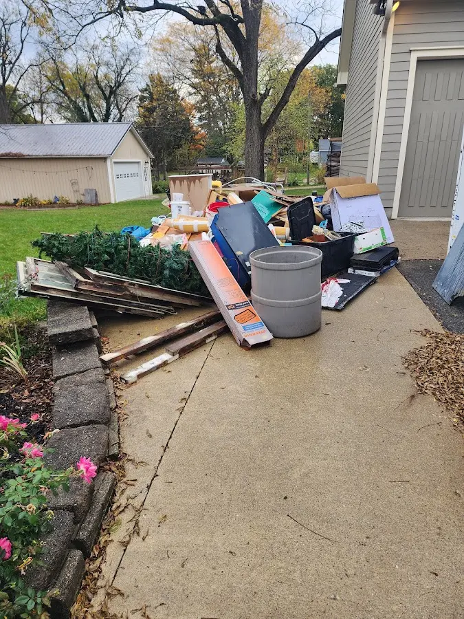 Dumpster being loaded with debris for 12 Yard Dumpster Rental in Litchfield